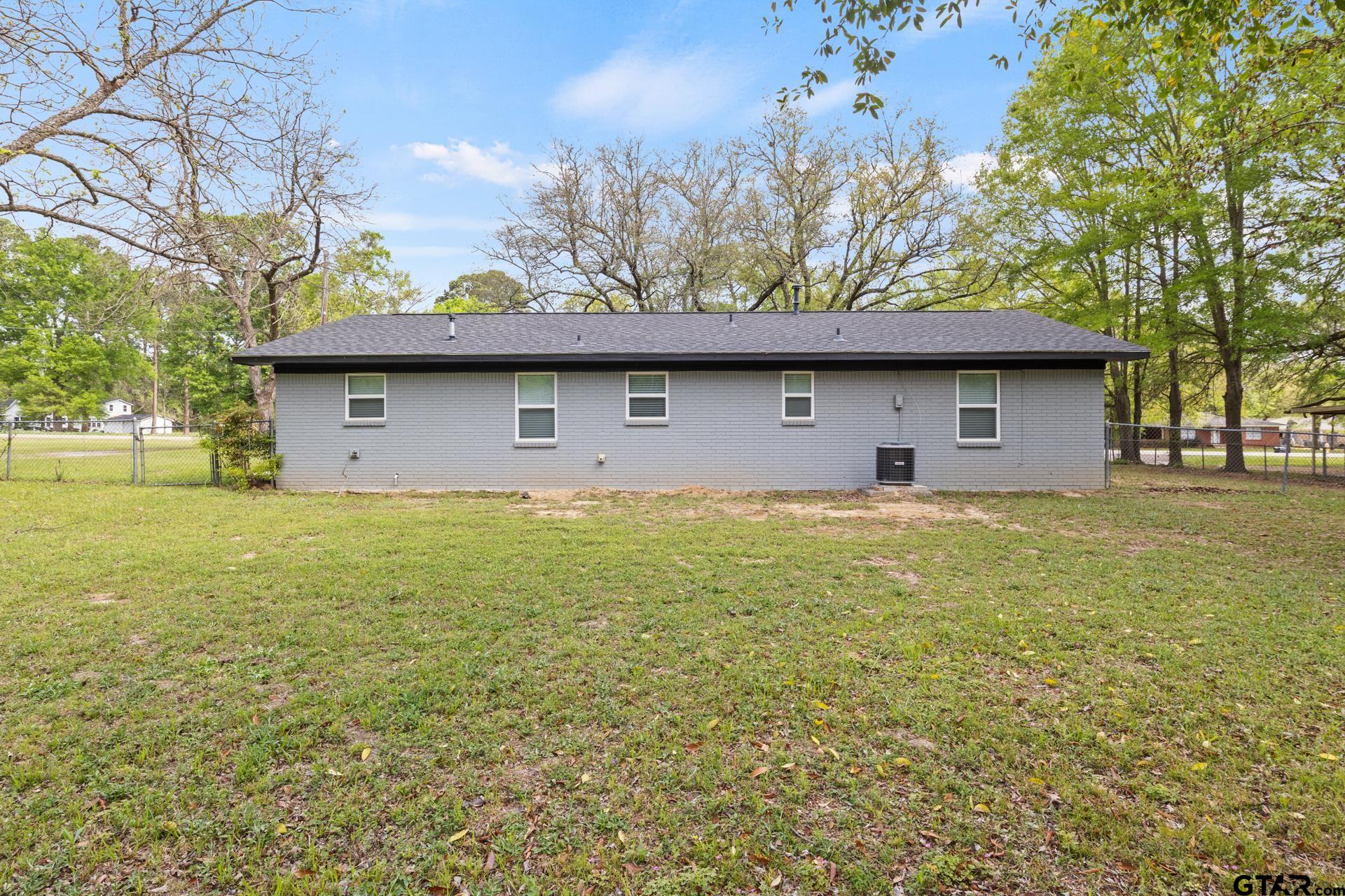 802 Quitman Street Pittsburg, TX 75686 - Photo 23 of 24 a front view of a house with a garden