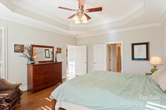 a bedroom with a bed and a chandelier