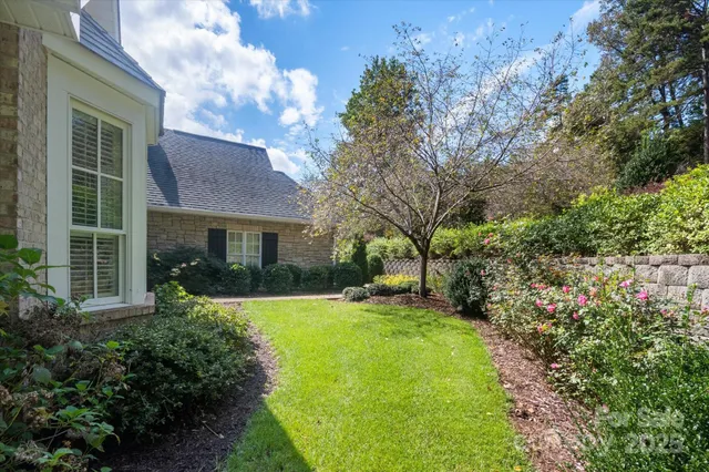 a view of a house with a yard and tree s