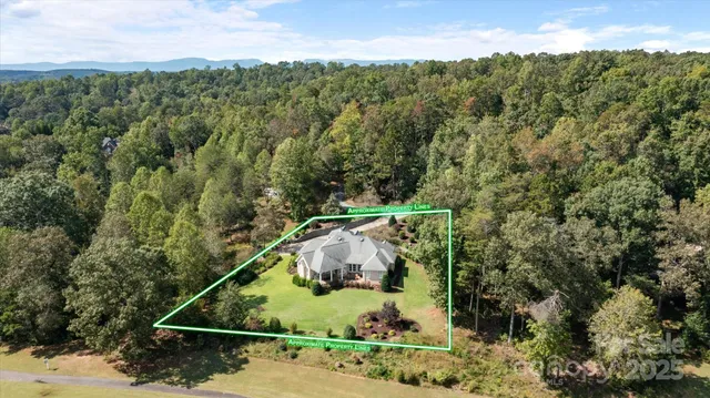 an aerial view of a houses with a yard