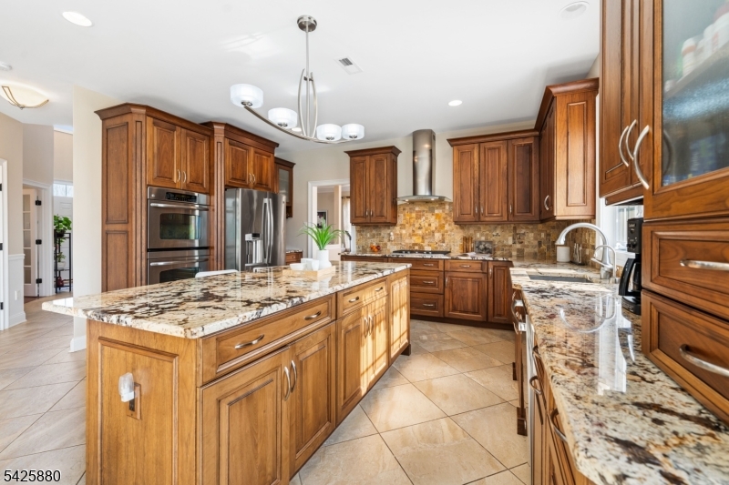 5 Rigger Court Hillsborough, NJ 08844 - Photo 15 of 42 a kitchen with kitchen island granite countertop a stove sink and cabinets