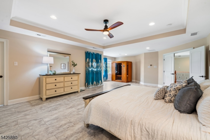 5 Rigger Court Hillsborough, NJ 08844 - Photo 23 of 42 a bedroom with a bed a chandelier and a dresser