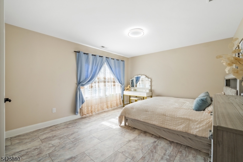 5 Rigger Court Hillsborough, NJ 08844 - Photo 30 of 42 a bedroom with a bed window and a table