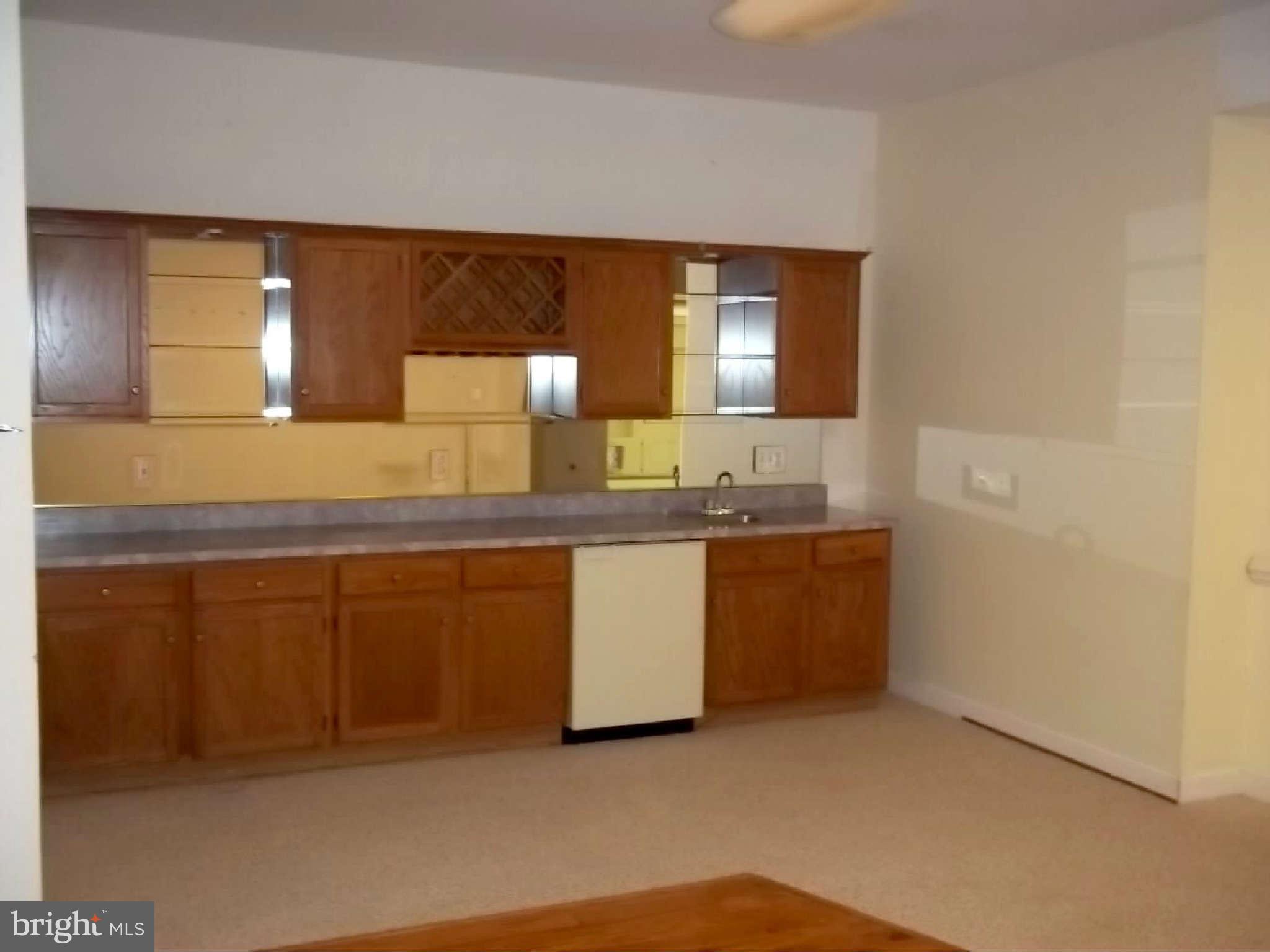 10608 Brooks Reserve Road Upper Marlboro, MD 20772 - Photo 20 of 23 a kitchen with granite countertop white cabinets and white appliances