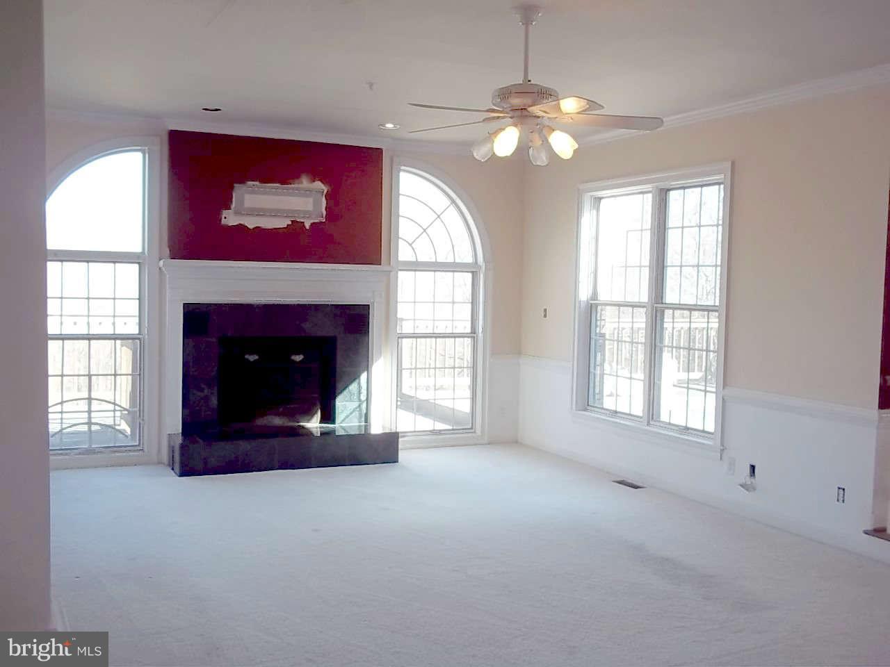 10608 Brooks Reserve Road Upper Marlboro, MD 20772 - Photo 5 of 23 a living room with furniture and a fireplace