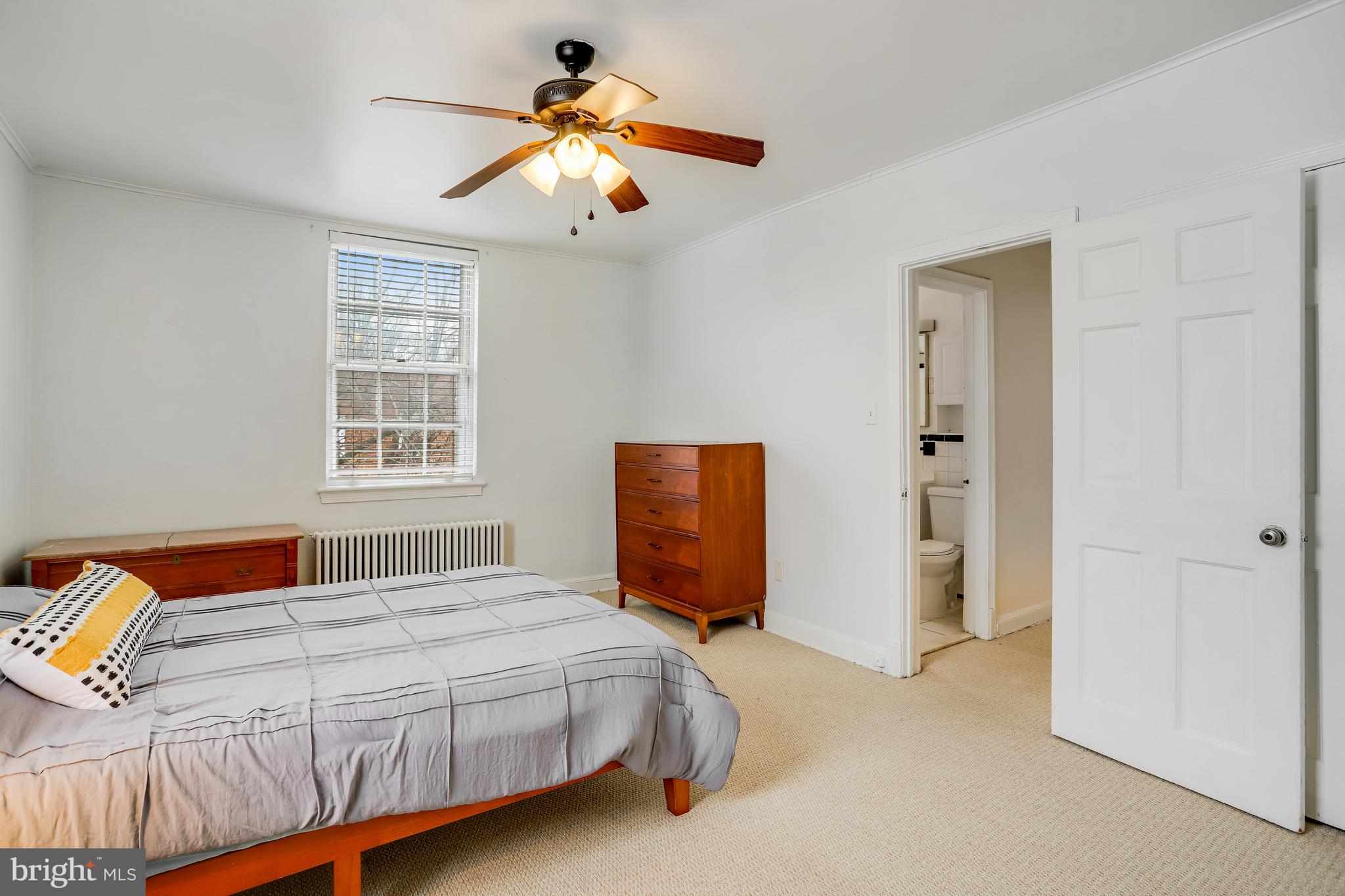 1446 Tuckerman Street Northwest, Unit 307 Washington, DC 20011 - Photo 15 of 18 a bedroom with a bed and a chandelier