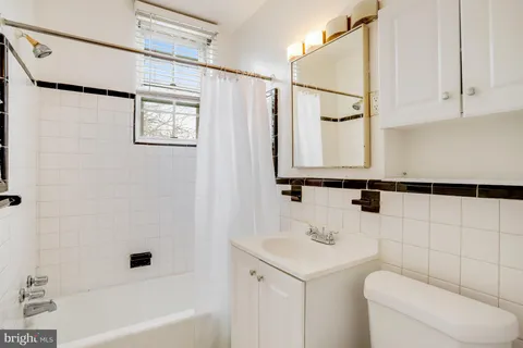 a bathroom with a sink a toilet and a bathtub