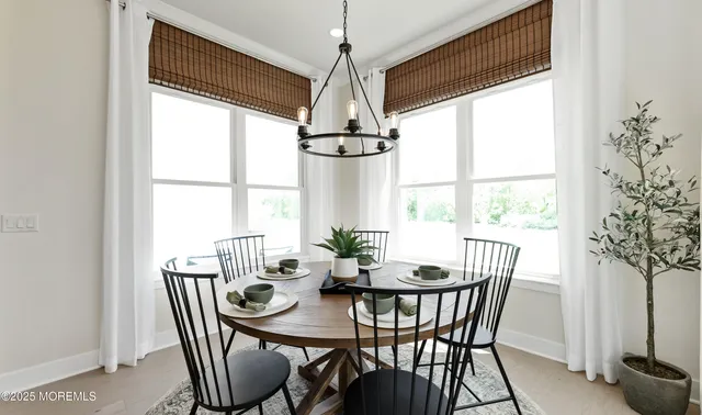 a dining room with furniture window and outside view