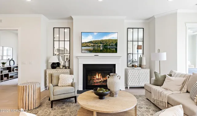 a living room with furniture a fireplace and a flat screen tv