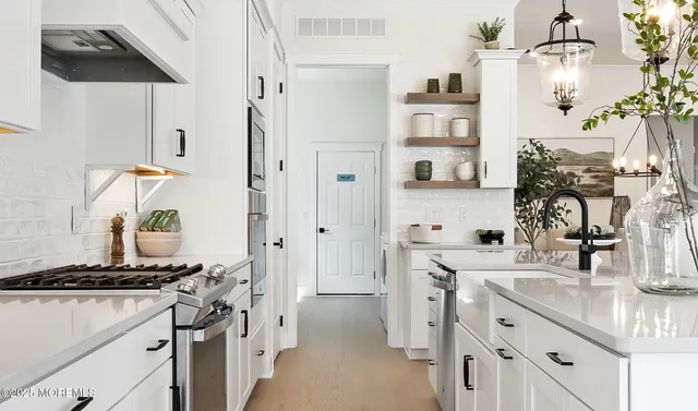 a kitchen with cabinets and stainless steel appliances