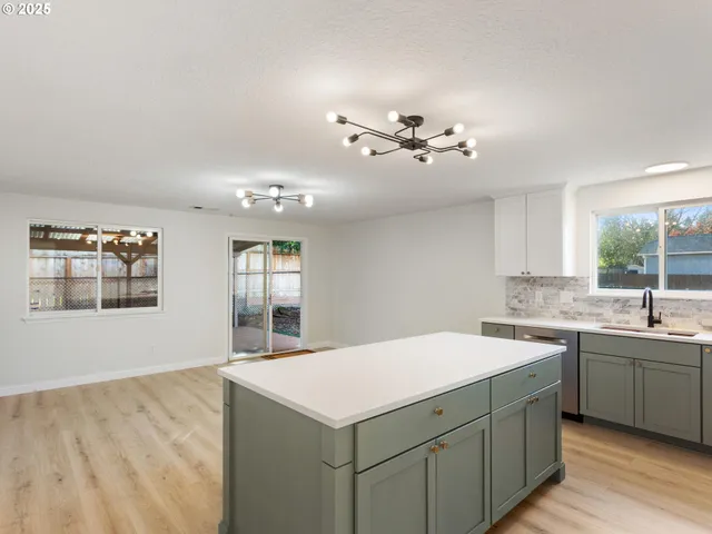 a view of an empty room with a chandelier fan