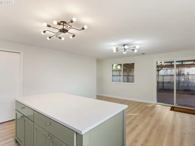 a kitchen with stainless steel appliances granite countertop a sink stove and microwave