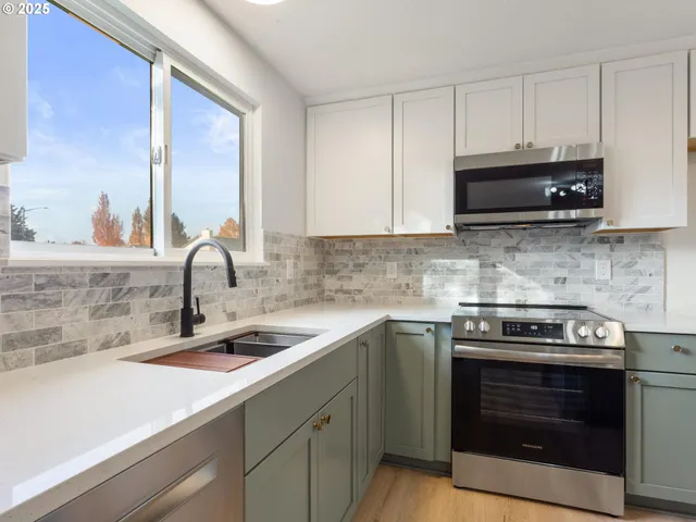 a kitchen with a sink stove and cabinets