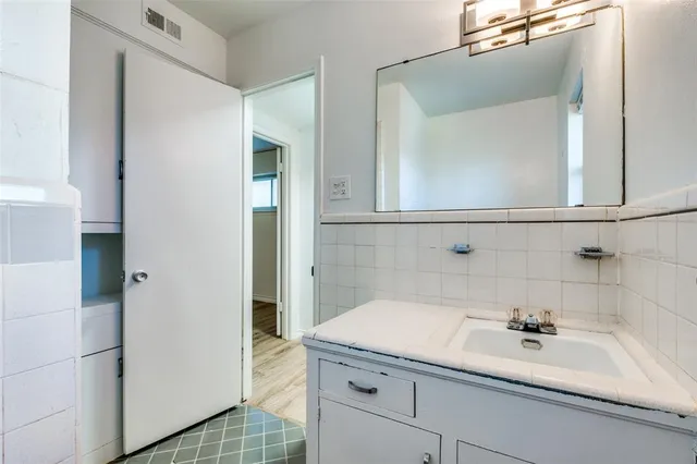 a bathroom with a sink toilet vanity and window