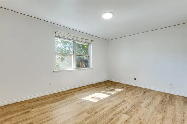 wooden floor in an empty room with kitchen