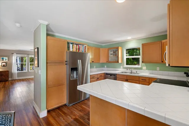 a kitchen with stainless steel appliances a refrigerator and a sink