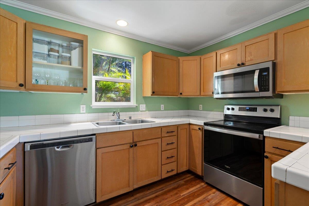 2740 Liholani Street, Unit 10 Pukalani, HI 96768 - Photo 20 of 50 a kitchen with a sink stove top oven and cabinets