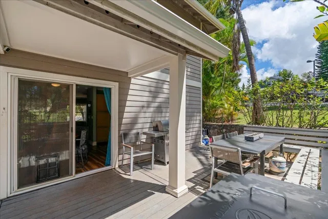 a view of a patio with table and chairs and floor to ceiling window