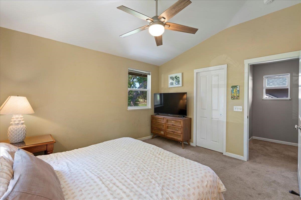 2740 Liholani Street, Unit 10 Pukalani, HI 96768 - Photo 37 of 50 a bedroom with a bed and a flat screen tv