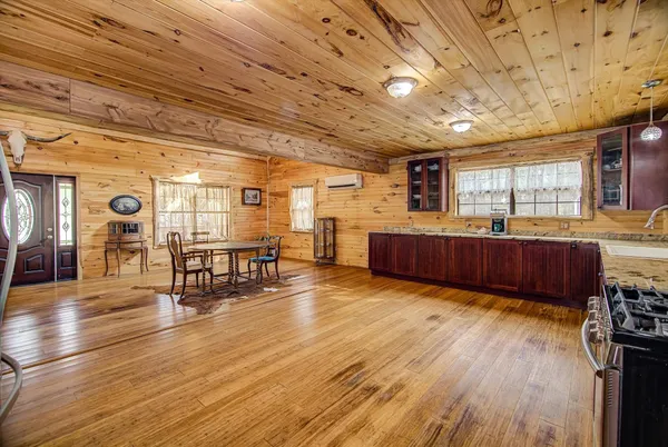a view of kitchen with furniture and wooden floors