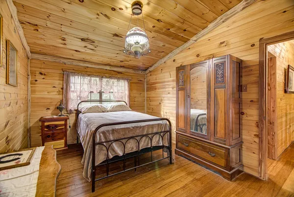 a bedroom with a bed next to a window