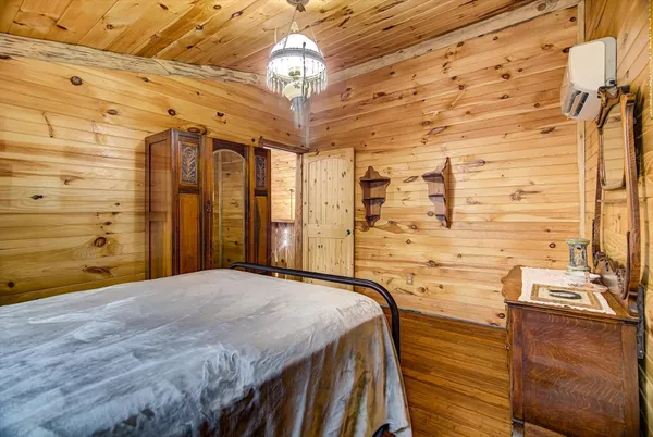 a bedroom with a bed and a chandelier