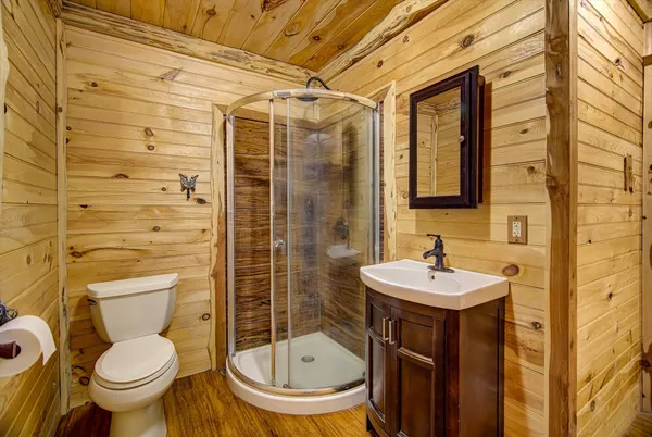 a bathroom with a sink toilet and shower