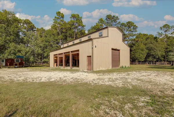 a view of a yard in front of a house with a large tree