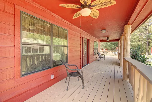a view of a balcony with chair and wooden floor