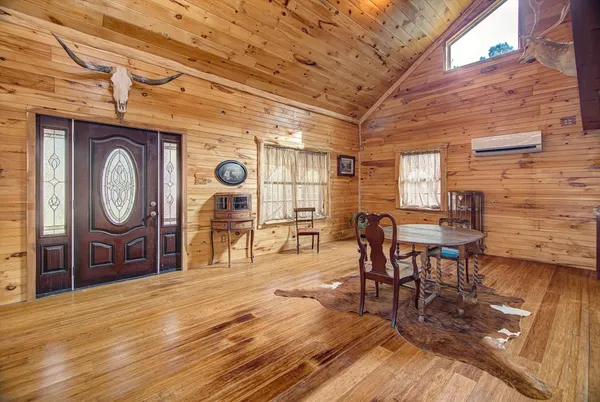 a living room with couch and a wooden floors