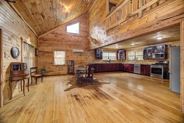 a view of a kitchen with furniture and wooden floor