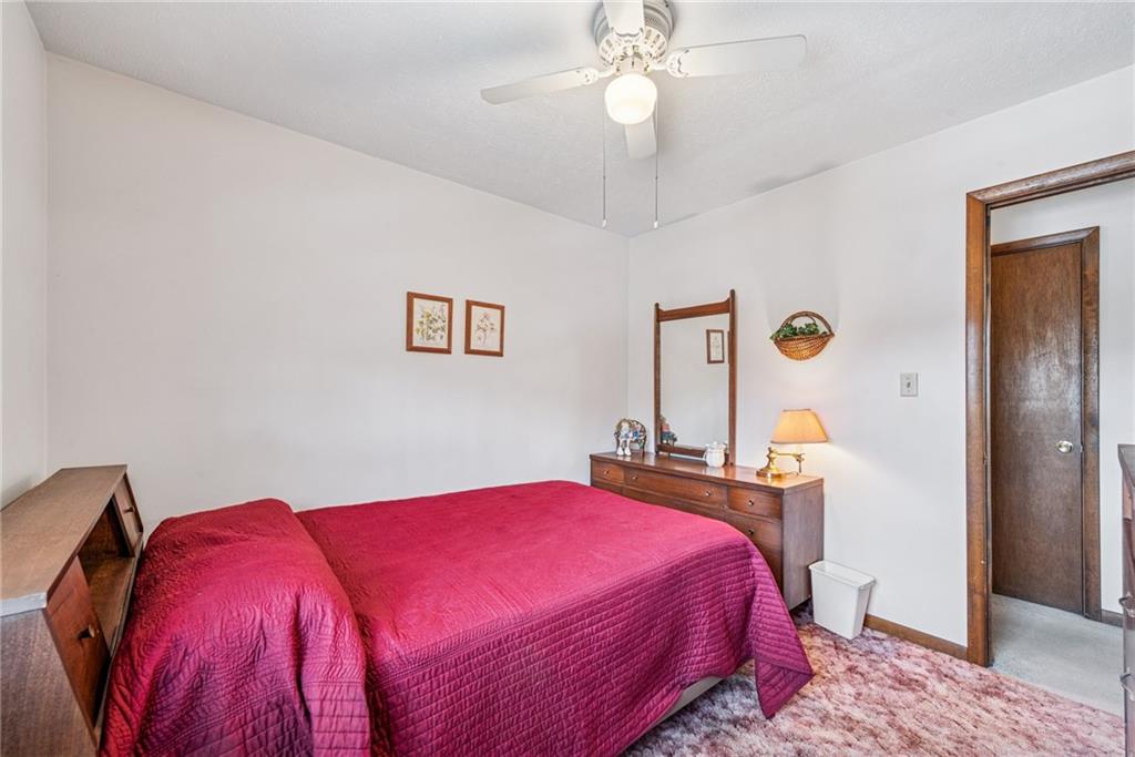 126 Wetzel Road Smock, PA 15480 - Photo 15 of 33 a bedroom with a bed and a chandelier
