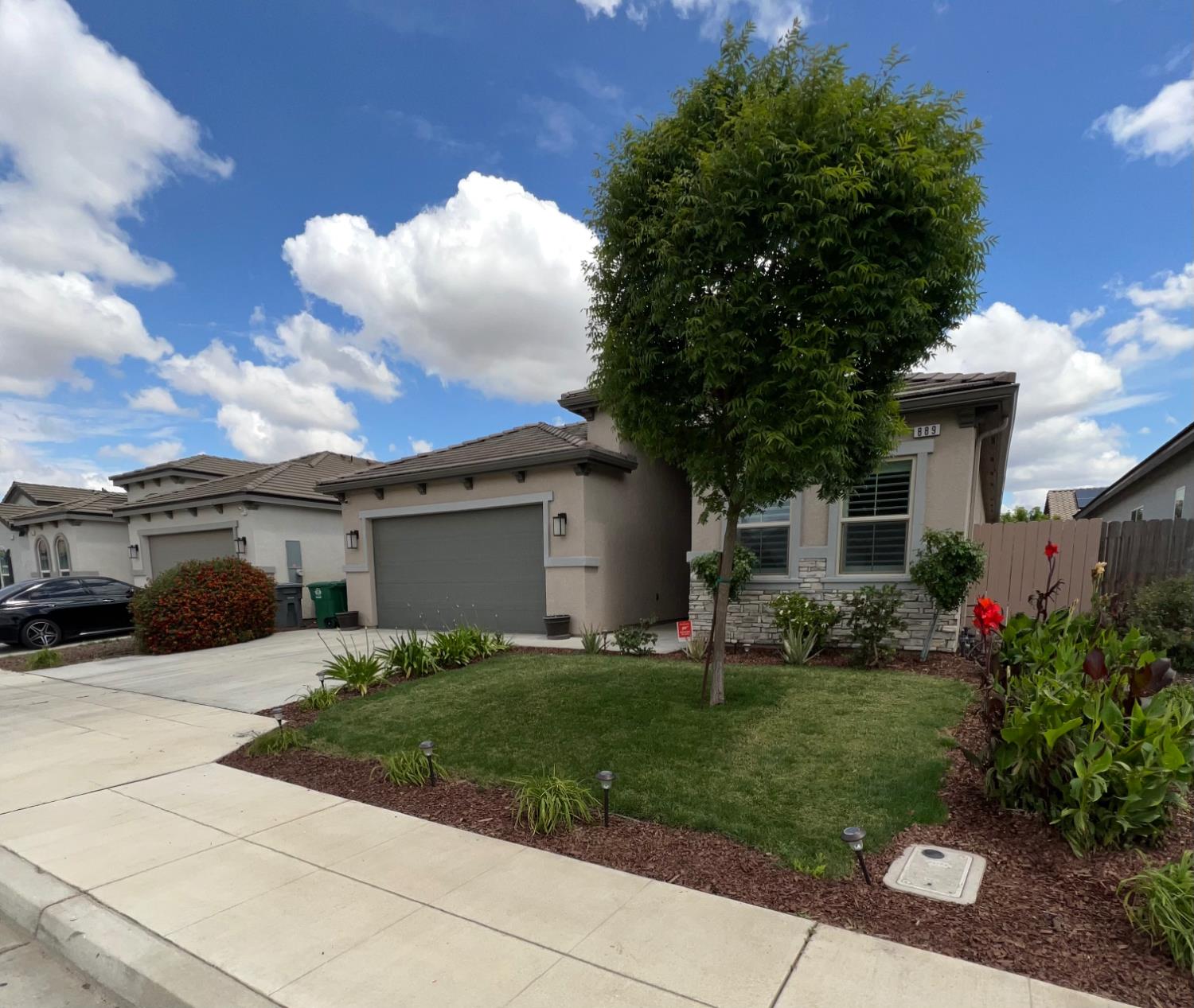 889 Coloma Place Madera, CA 93637 - Photo 3 of 61 a front view of a house with a yard and trees