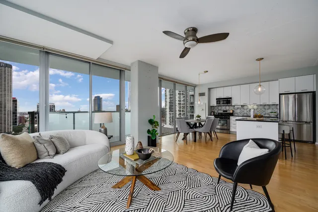 a living room with furniture and a view of kitchen