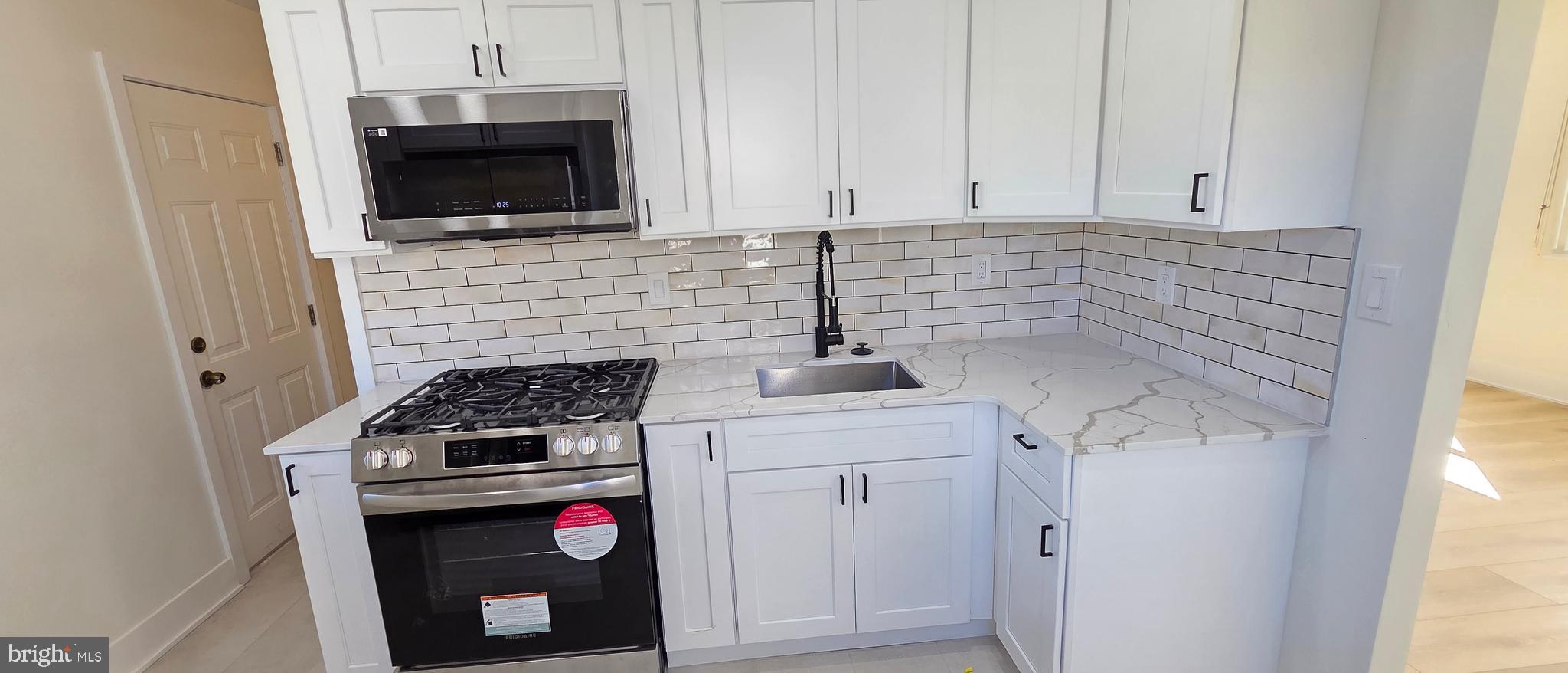 3731 Dresher Road Bensalem, PA 19020 - Photo 4 of 8 a kitchen with stainless steel appliances white cabinets and a stove