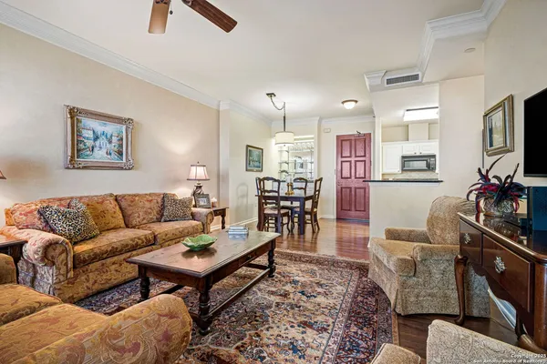 a living room with furniture a flat screen tv and a table