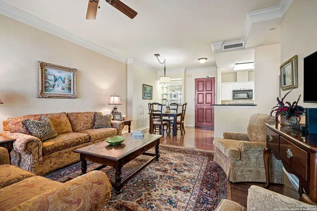 a living room with furniture a flat screen tv and a table