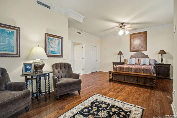 a spacious bedroom with a bed and a couch