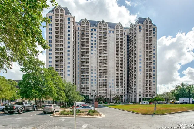 front view of a building with a garden
