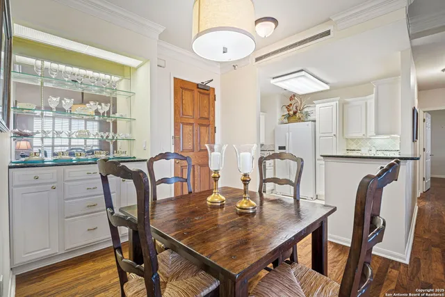 a view of a a dining room with furniture window and wooden floor