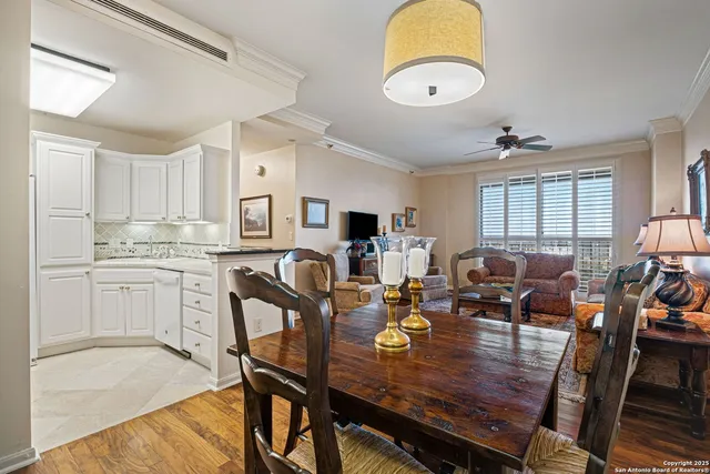 a view of a dining room and livingroom with furniture window and wooden floor