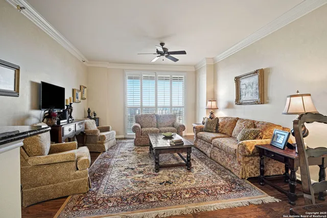 a living room with furniture a rug and a flat screen tv
