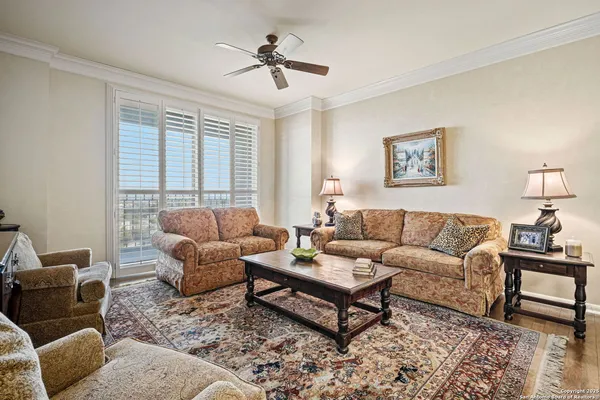 a living room with furniture a rug and a window