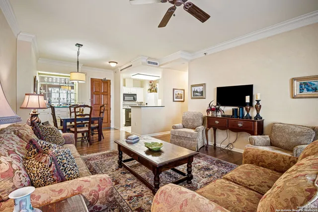 a living room with furniture a flat screen tv and a table