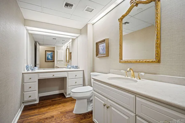 a bathroom with a toilet sink and mirror