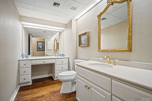 a bathroom with a toilet sink and mirror