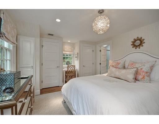 23 Bogle Street Weston, MA 02493 - Photo 17 of 23 a bedroom with a bed and a chandelier