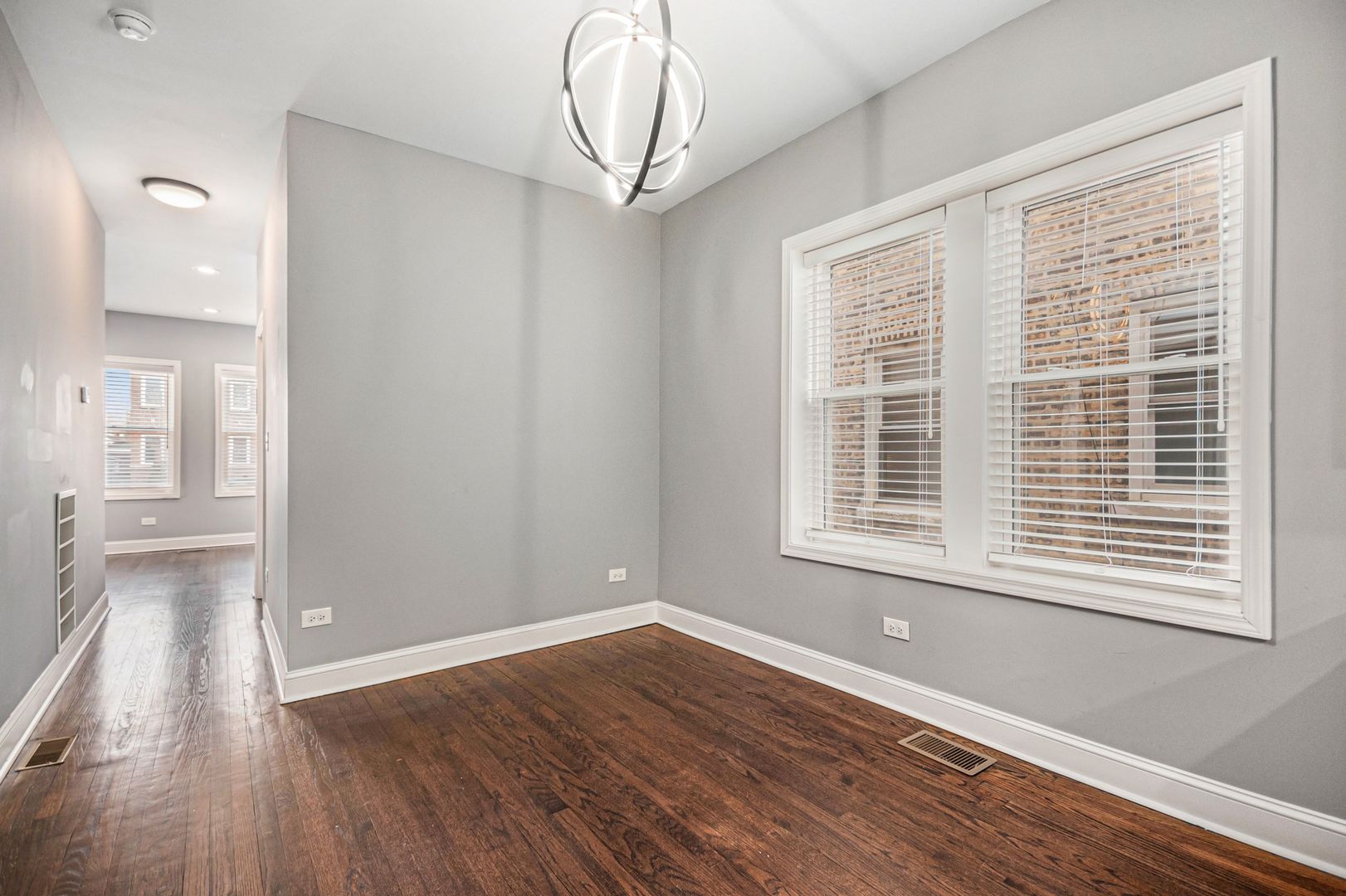 1702 North Meade Avenue, Unit 1 Chicago, IL 60639 - Photo 12 of 14 a view of an empty room with wooden floor and a window
