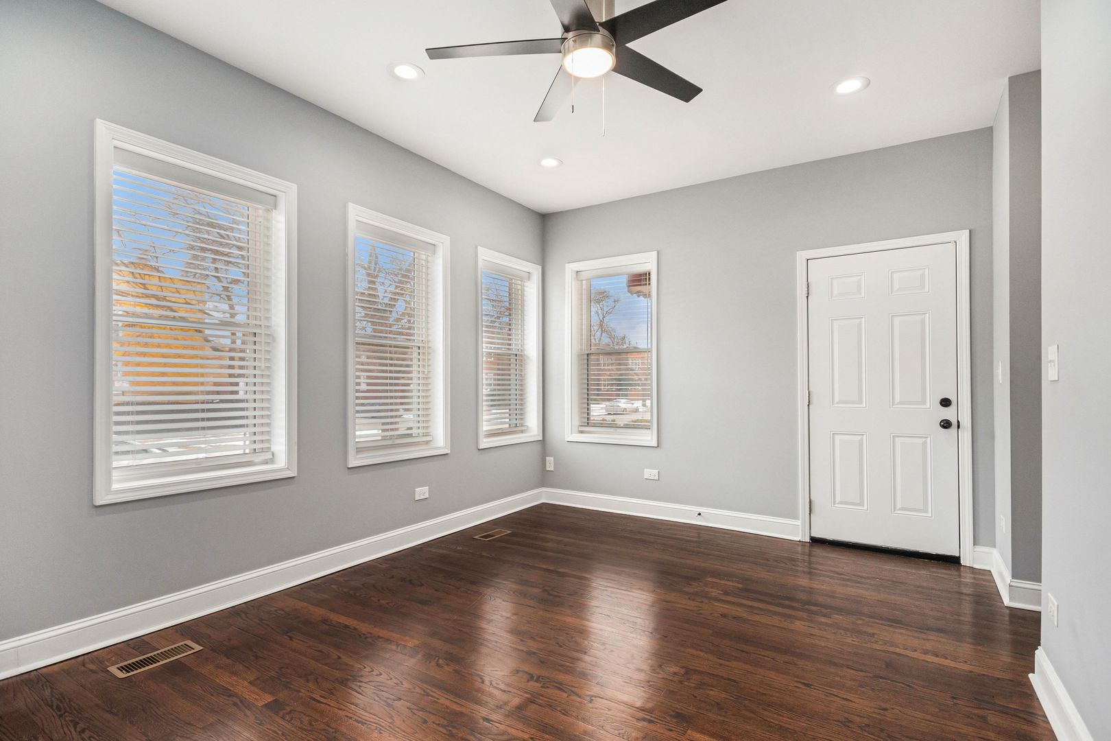 1702 North Meade Avenue, Unit 1 Chicago, IL 60639 - Photo 3 of 14 a view of an empty room with wooden floor and a window