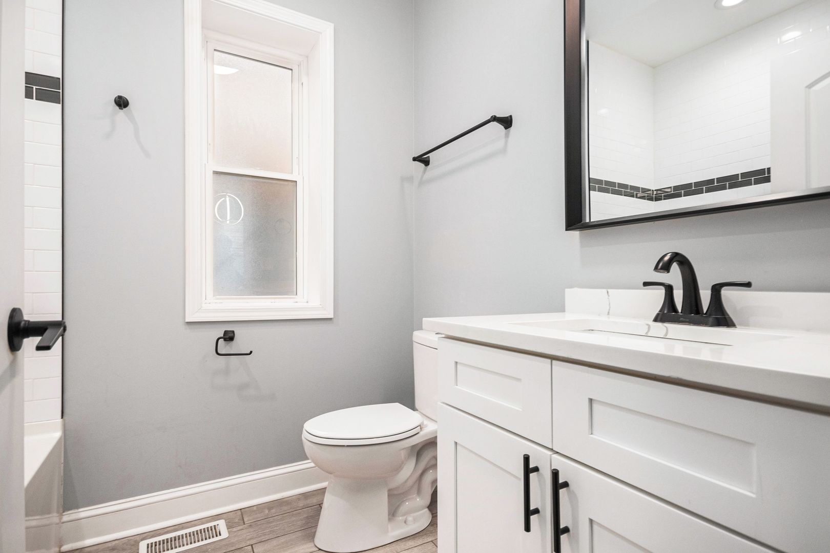 1702 North Meade Avenue, Unit 1 Chicago, IL 60639 - Photo 6 of 14 a bathroom with a toilet a sink and mirror